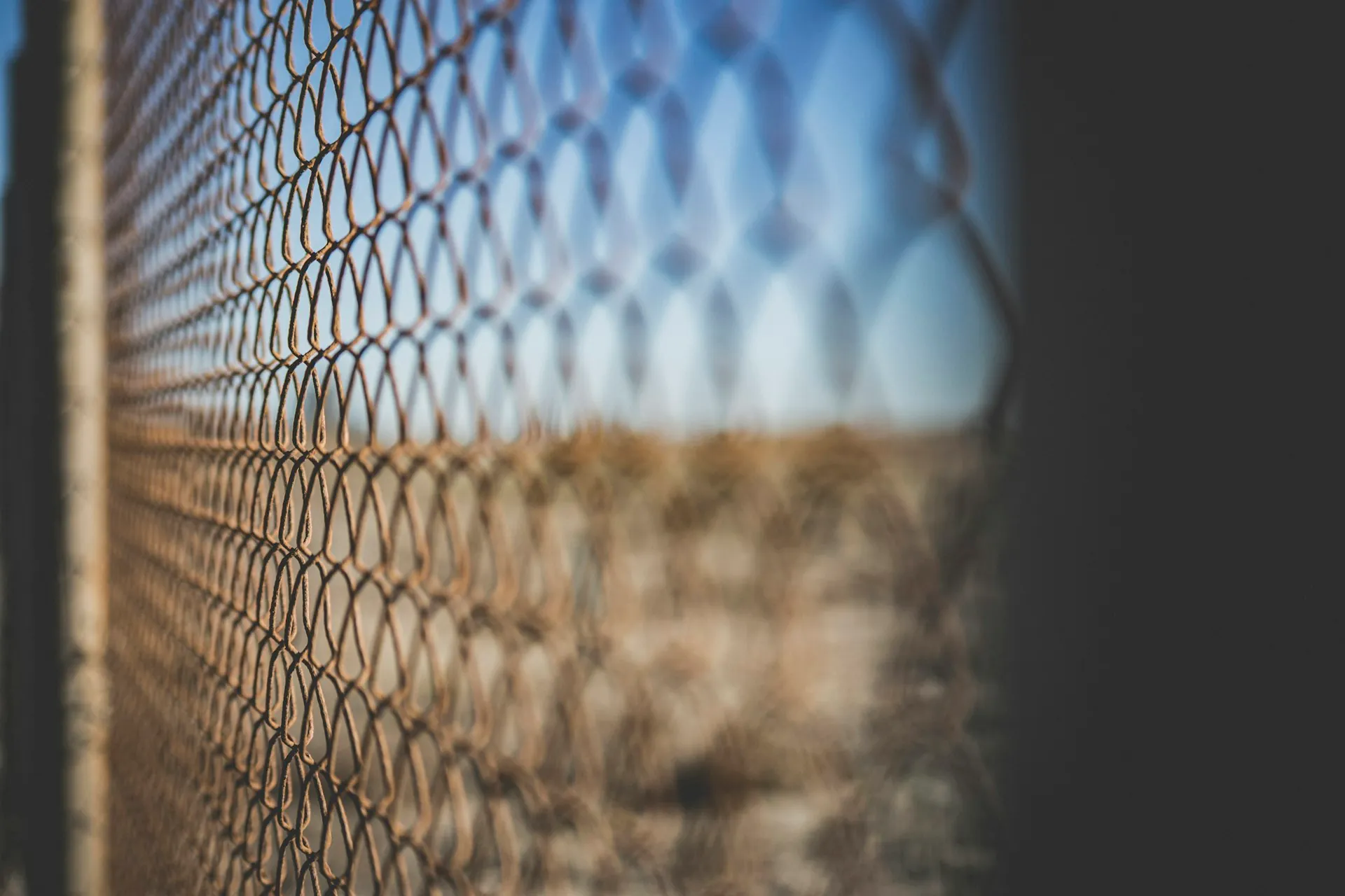 Galvanized chain link fence under a clear blue sky in Montgomery, IL